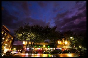 night view of building lit up under cloudy sky